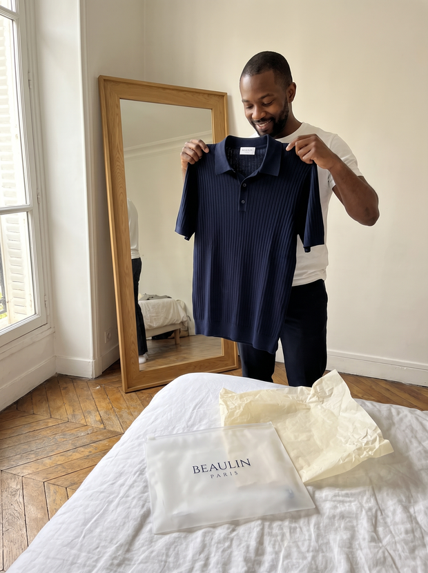 Customer opening a Beaulin Paris pouch on a bed - Beaulin Paris